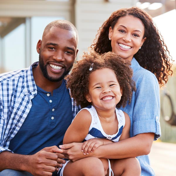 family of three smiling